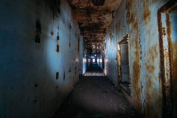 Dark creepy corridor in abandoned nuclear power plant in Crimea. First person view, going with flashlight in dirty grunge tunnel in ruined building, horror escape — Stock Photo, Image