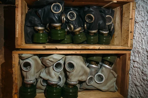 Wooden box with old vintage gas masks, anti pollution protection, close up — 스톡 사진