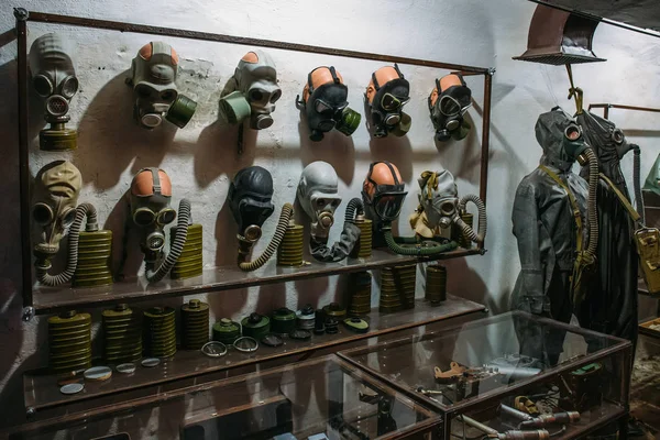 Stand with old vintage gas masks in USSR military bunker — Stock Photo, Image