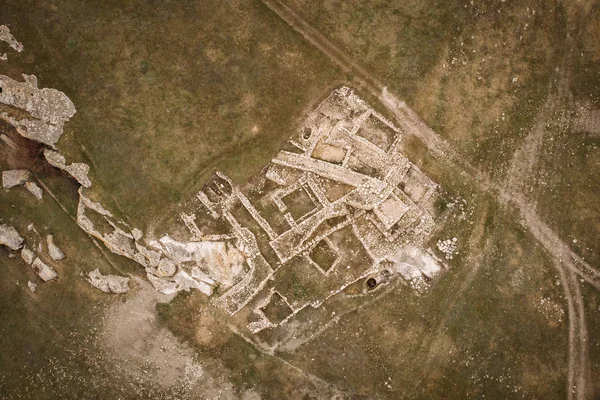 Archaeological ancient ruins of ancient buildings in Crimea, aerial top down view