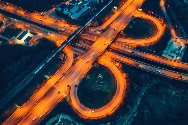 Aerial view of transport junction, city roads, top view from drone, car traffic at night — Stock Photo, Image