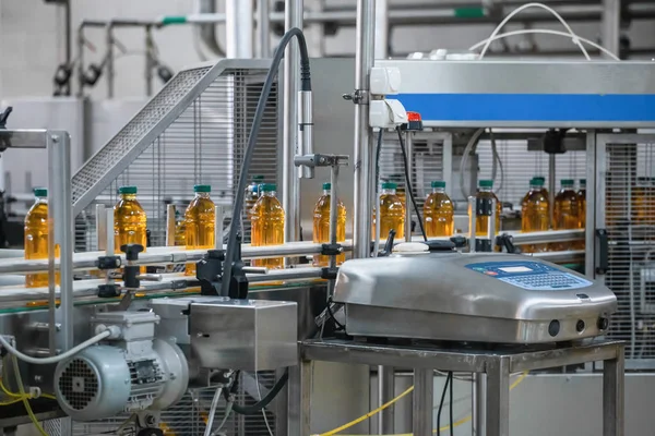 Automatic conveyor belt of production line of juice on beverage plant or factory, modern computerized industrial equipment