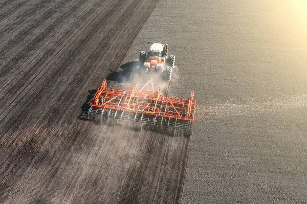 Top view of agricultural industrial tractor plows soil field for sowing , aerial view. Land cultivation — Stock Photo, Image