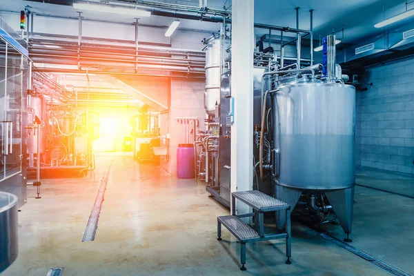 Interior de la fábrica industrial, tuberías de acero, tubos en la producción de bebidas con equipos de herramientas, azul tonificado con luz roja —  Fotos de Stock