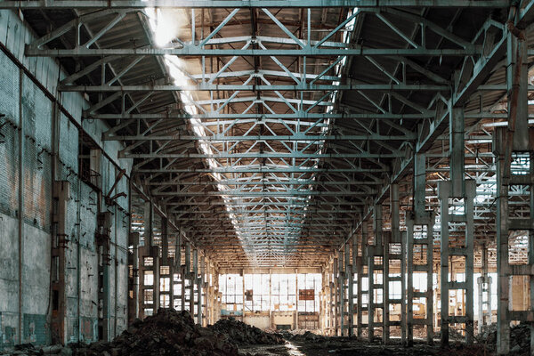 Ruined industrial hall of warehouse or hangar in process of reconstruction, toned