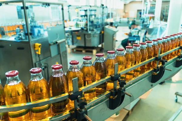 コンベアベルト、飲料工場や工場内装のボトルに入ったジュース(青色)、工業生産ライン — ストック写真