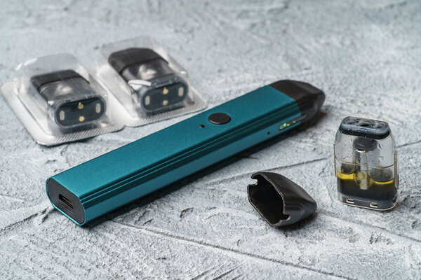 Vape pod system or pod mod with changeable cartridges close up - newest generation of vaping products - small size devices for inhaling higher nicotine strengths