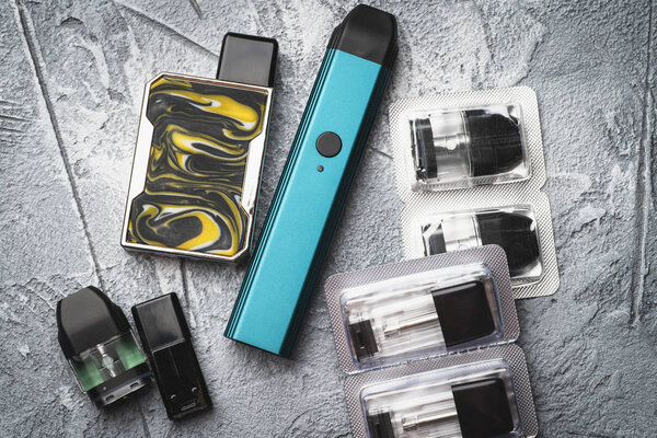 Vape pod system or pod mod with changeable cartridges close up - newest generation of vaping products - small size devices for inhaling higher nicotine strengths