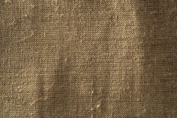 Tessuto texture primo piano, ruvido sfondo marrone tela, macro colpo — Foto Stock