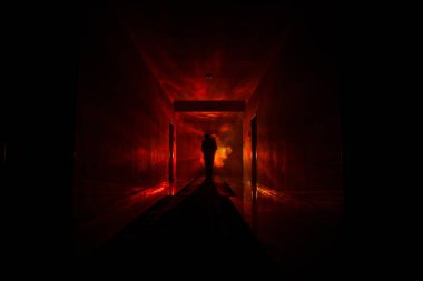 Creepy silhouette in the dark abandoned building. Horror about maniac concept or Dark corridor with cabinet doors and lights with silhouette of spooky horror person standing with different poses. clipart