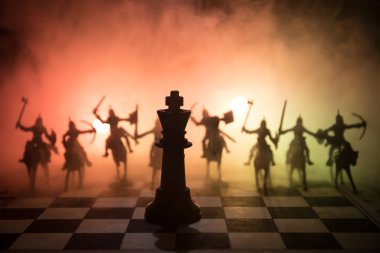 Süvari ve satranç tahtası üzerinde piyade ile ortaçağ savaş sahnesi. Satranç oyununu kavramı iş fikirleri ve rekabet ve strateji fikirler duman ve sis karanlık bir arka plan üzerinde satranç figürleri.