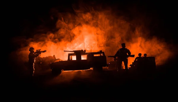 War Concept. Military silhouettes fighting scene on war fog sky background, Fighting silhouettes Below Cloudy Skyline At night. Battle scene. Army jeep vehicle with soldiers. army jeep