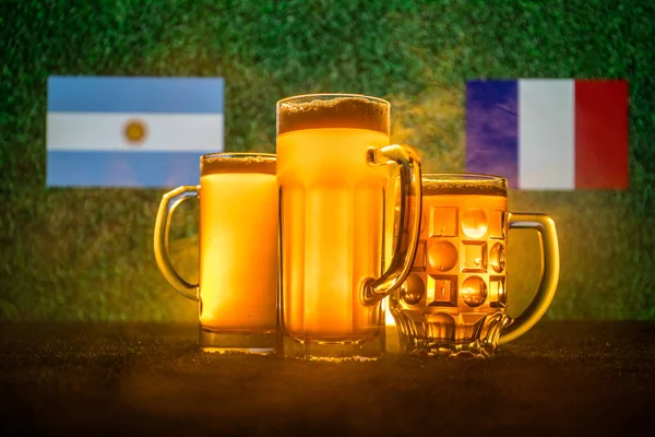Soccer 2018. Creative concept. Beer glasses on grass. Support your country with beer concept. Selective focus