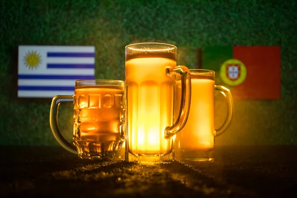 Soccer 2018. Creative concept. Beer glasses on grass. Support your country with beer concept. Selective focus