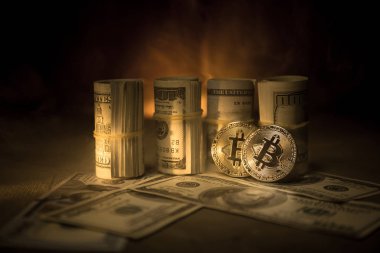 Bitcoin (sanal para) para ile toplu bize dolar koyu tonda sisli arka plan üzerinde. Seçici odak. Dijital para ve Bitcoin kavramı.