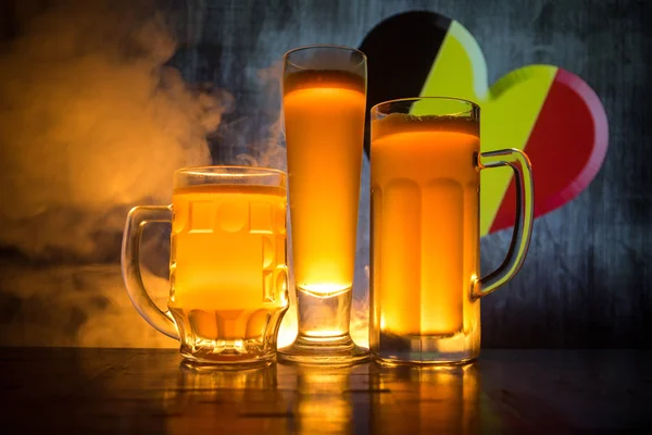 Soccer 2018. Beer glasses on table at dark toned foggy background. Support Belgium with beer concept. Selective focus