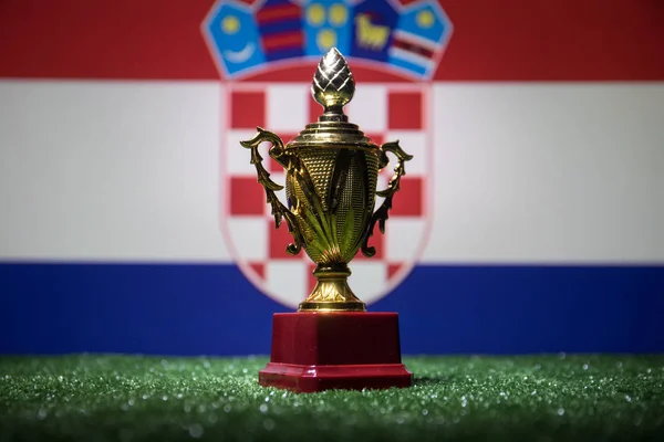 Croatia flag, golden champion\'s cup on grass.Concept sport. Selective focus