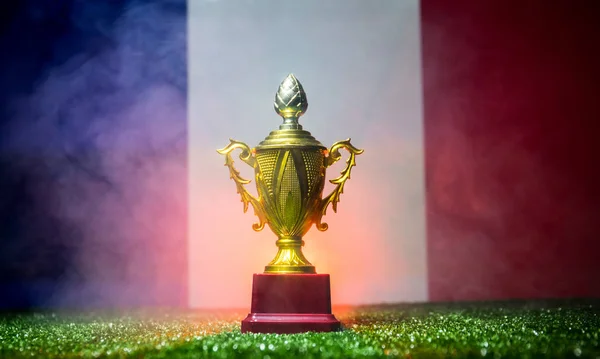 France flag, golden champion\'s cup on grass.Concept sport. Selective focus