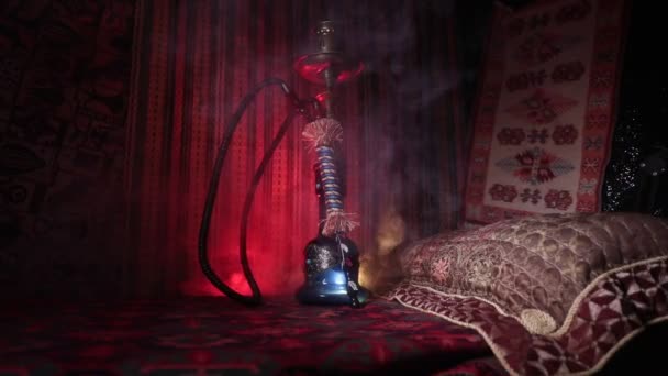 水烟碗上的水烟热煤制作阿拉伯内部的蒸汽云 地毯上的东方装饰品 时尚的东方水烟在黑暗中与背光 滑块射击 空空间 — 图库视频影像