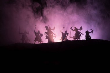 Süvari ve piyade ile ortaçağ savaş sahnesi. Siluetleri şekiller ayrı nesneler olarak mücadele koyu tonda sisli arka plan savaşçılar arasında. Gece sahne. Seçici odak