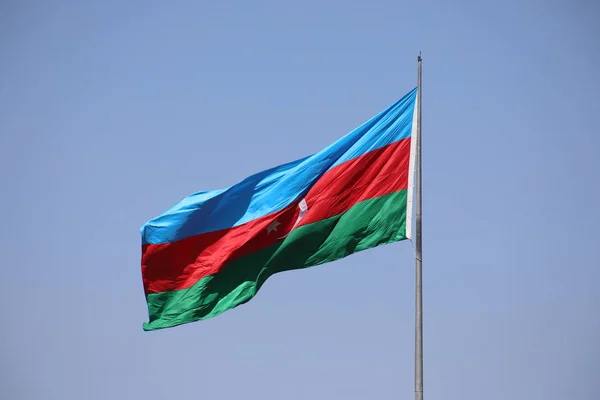 Azerbaijan flag in Baku, Azerbaijan. National sign background. Red Green Blue flag. Azerbaijan national flag with Crescent moon. Flags waving wind