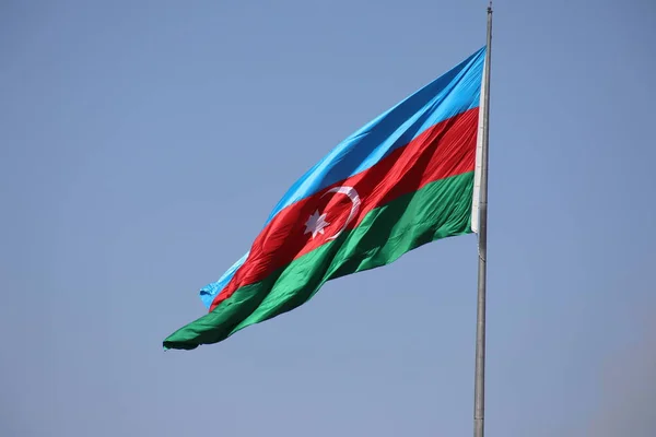 Azerbaijan flag in Baku, Azerbaijan. National sign background. Red Green Blue flag. Azerbaijan national flag with Crescent moon. Flags waving wind