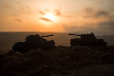 Savaş kavramı. Askeri savaş sis gökyüzü arka plan, Dünya Savaşı askerler siluetleri aşağıda bulutlu manzarası gün batımında dövüş sahnesinde siluetleri. Saldırı sahne. Zırhlı araçlar. tank içinde hareket