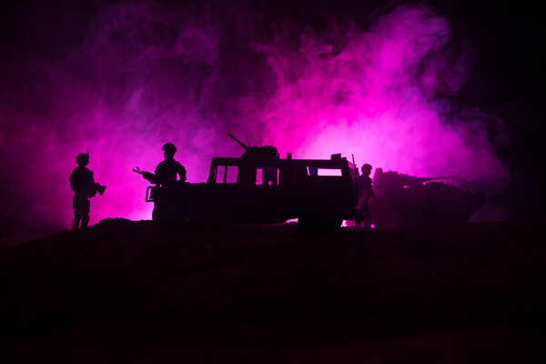 War Concept. Military silhouettes fighting scene on war fog sky background, Fighting silhouettes Below Cloudy Skyline At night. Battle scene. Army jeep vehicle with soldiers. army jeep