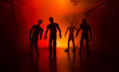 Ürpertici siluet koyu terk edilmiş binada. Zombi kıyamet genel kavram ya da korkunç korku zombi farklı pozlar ile ayakta siluetleri ile karanlık koridor.