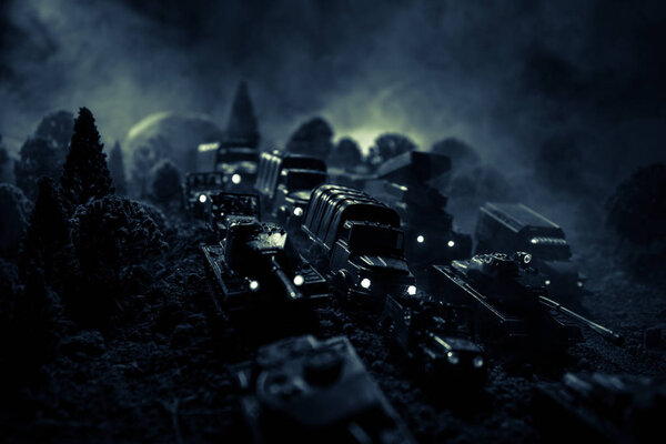 War Concept. Military silhouettes fighting scene on war fog sky background, World War Soldiers Silhouettes Below Cloudy Skyline At night. Attack scene. Armored vehicles. Selective focus. Decoration