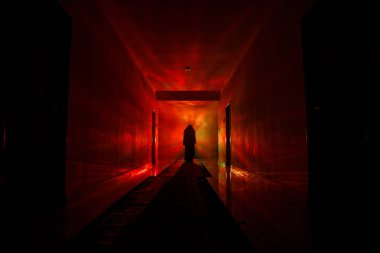Ürpertici siluet koyu terk edilmiş binada. Manyak genel kavram ya da kabine kapılar ile karanlık koridor ve ışıkları ile farklı pozlar duran korkunç korku kişi silueti ile ilgili korku.