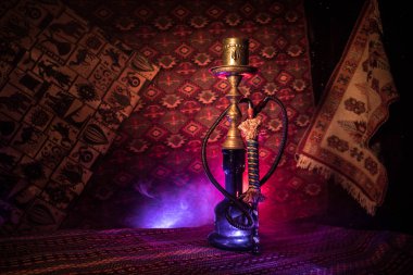 Nargile kömürü nargile kupa Arap iç de buhar bulutları yapma. Şark süsleme halı üzerinde. Şık oryantal shisha içinde karanlık arka ışık ile. Shisha reklam için. Seçici odak