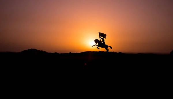 Attacking scene. War concept. Riders on horse ready to fight and soldiers on a dark foggy toned sunset background. Battle scene battlefield of fighting soldiers. Selective focus