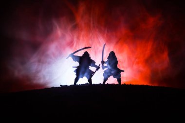 Düelloda iki samurais silüeti. İki samurais ve günbatımı gökyüzü ile hayal et. Seçici odak