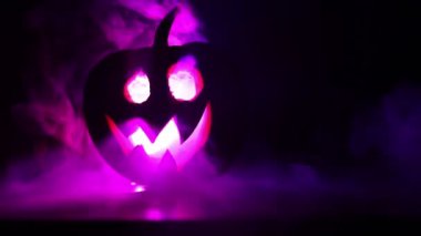 Kaymak vurdu. Korkunç Halloween kabak oyma gözleri ve yangın ve sis karanlık bir arka plan üzerinde mum içinde yanma ile bir gülümseme ile. Boş alanı. Seçici odak