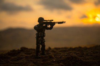 Silhouette of military soldier or officer with weapons at sunset. shot, holding gun, colorful sky, mountain, background. Decoration with toy soldier clipart