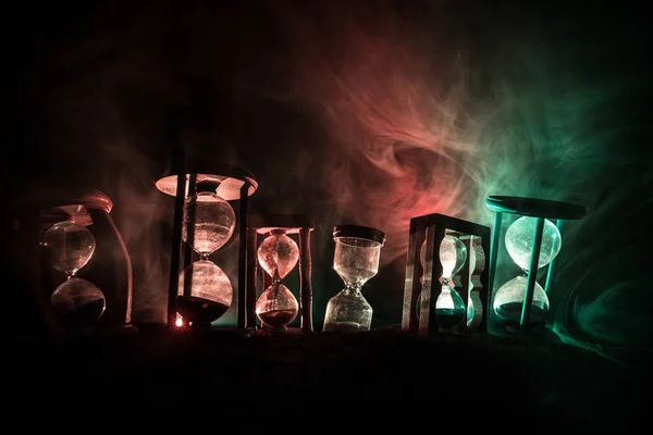 Time Concept Silhouettes Hourglasses Dark Toned Foggy Background Back Lighting — Stock Photo, Image