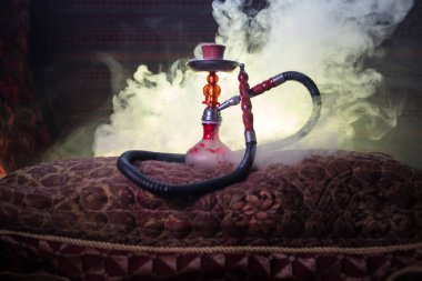 Nargile kömürü nargile kupa Arap iç de buhar bulutları yapma. Şark süsleme halı üzerinde. Şık oryantal shisha aydınlatmalı. Shisha reklam için. Seçici odak