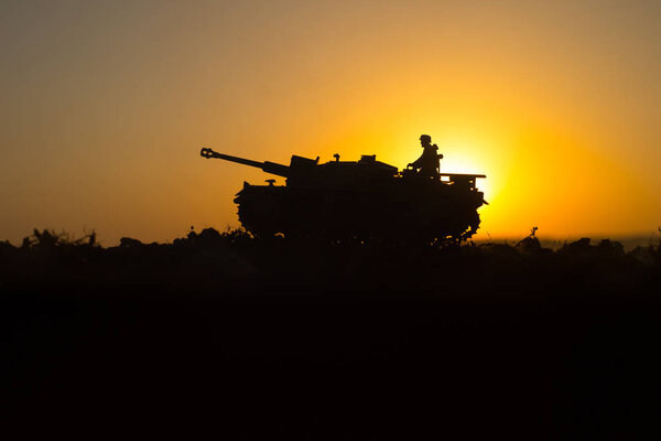 War Concept. Military silhouettes fighting scene. World War German Tanks and soldiers silhouettes at sunset. Attack scene. Armored vehicles. Tanks battle