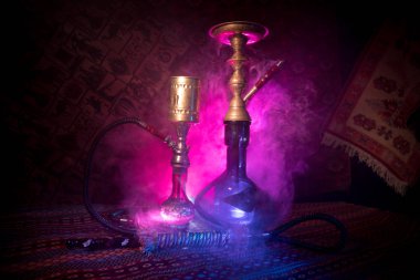 Nargile kömürü nargile kupa Arap iç de buhar bulutları yapma. Şark süsleme halı üzerinde. Şık oryantal shisha içinde karanlık arka ışık ile. Shisha reklam için. Seçici odak