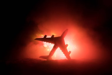 Air Crash. Burning falling plane. The plane crashed to the ground. Decorated with toy at dark fire background. Air accident concept. Selective focus clipart