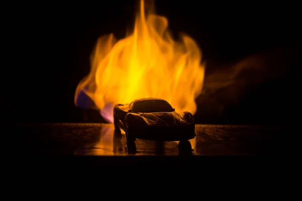 The car in the shadows with glowing lights in low light, or silhouette of sport car dark background. Selective focus