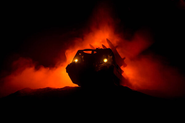 Rocket launch with fire clouds. Battle scene with rocket Missiles with Warhead Aimed at Gloomy Sky at night. Rocket vehicle on War Backgound. Selective focus