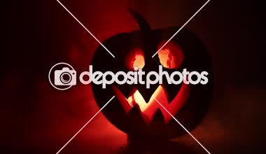 Cadılar Bayramı balkabağı gözlü gece parti için gülümseme ve scrary. İçinde siyah arka plan parlayan gözlerle korkunç Cadılar Bayramı Balkabağı görünümünü kapatın. Seçici odak