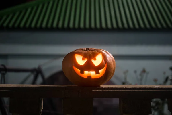Halloween pumpkin. Carved Halloween pumpkin glowing in the dark. Outdoor shot