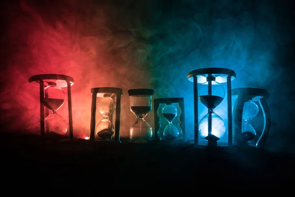 Time Concept Silhouettes Hourglasses Dark Toned Foggy Background Back Lighting — Stock Photo, Image