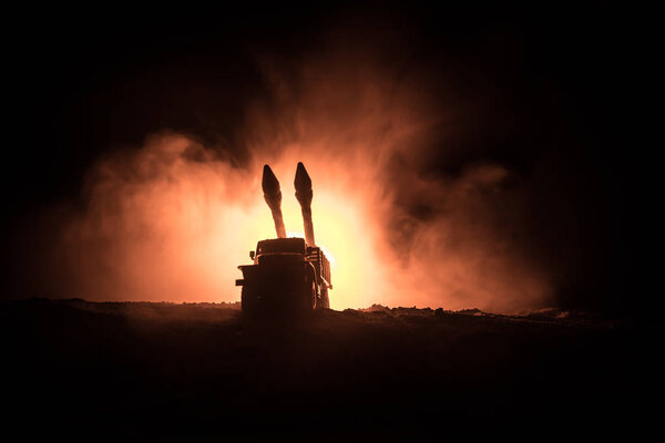 Rocket launch with fire clouds. Battle scene with rocket Missiles with Warhead Aimed at Gloomy Sky at night. Rocket vehicle on War Backgound. Selective focus