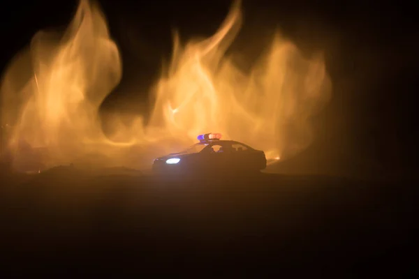 Police car chasing a car at night with fog background. 911 Emergency response police car speeding to scene of crime. Selective focus