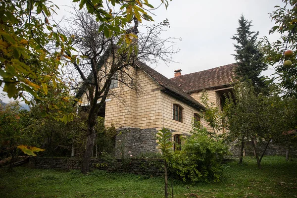 Beautiful landscape village house with trees at the forest during autumn, Azerbaijan countryside