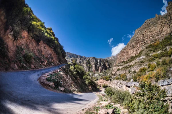 Cycling mountain road. Misty mountain road in high mountains.. Cloudy sky with mountain road